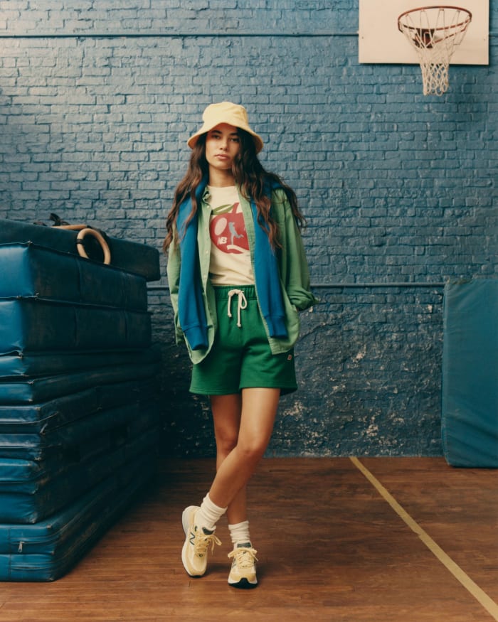 Female model poses in New Balance clothing.